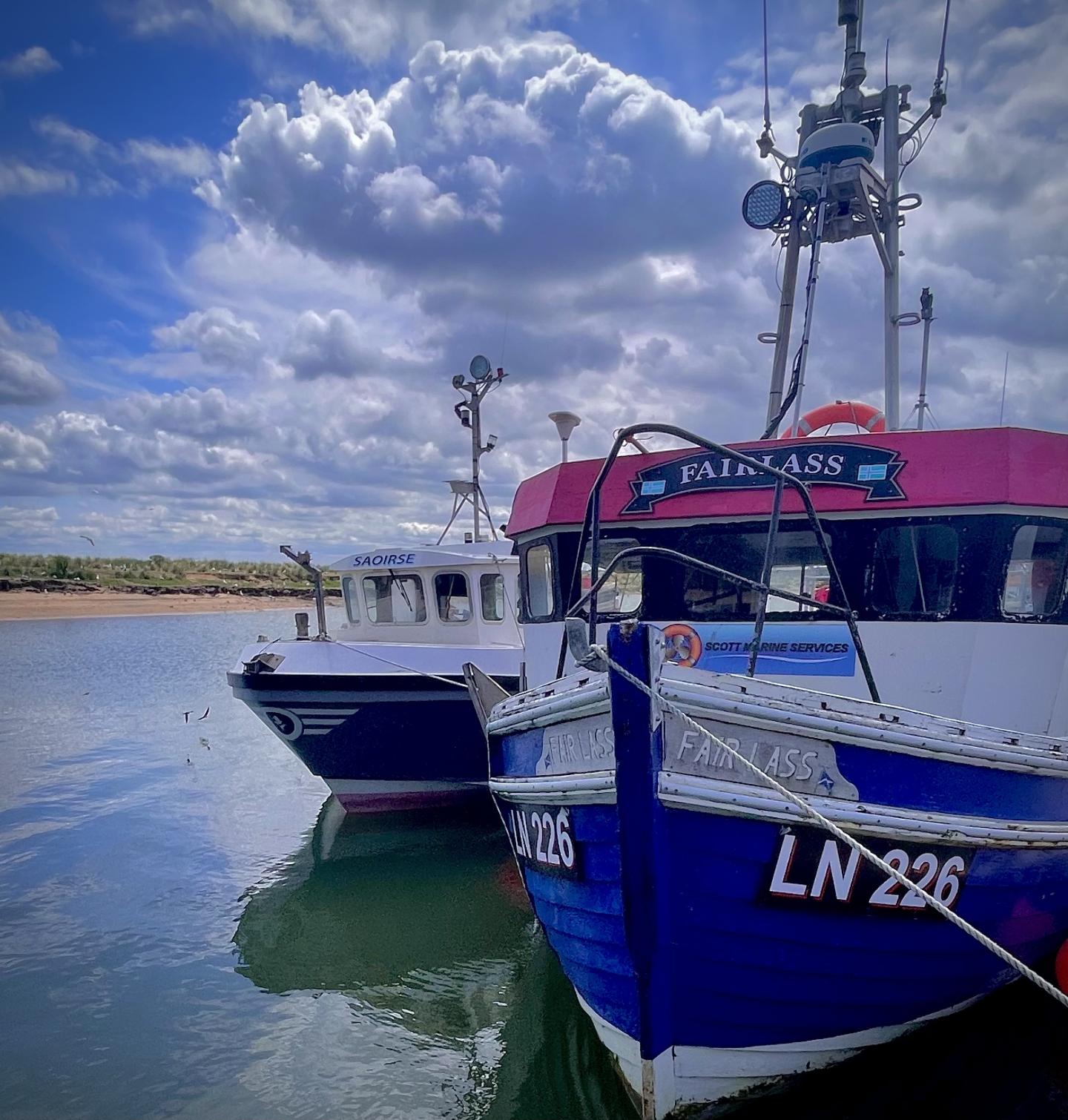 Two small fishing boats at sea